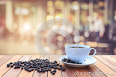 White coffee cup and coffee beans on wood table with blurred bac Stock Photo