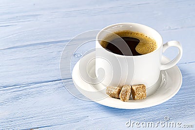 White Coffee cup side view on old wooden table. Aromatic coffee drink in white cup on light blue wooden table Stock Photo