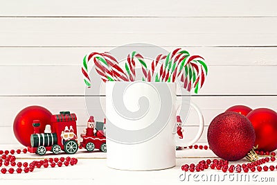 White coffee mug with candy canes and Christmas decorations on w Stock Photo