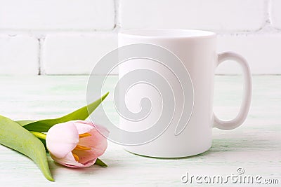 White coffee mug mockup with pink tulip Stock Photo