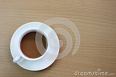 white coffee mug placed on a brown wooden table Stock Photo