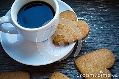 White coffeecup with hot fresh beverage and heart-shaped gingerbread biscuits. Coffee break with love. Side of coffee Stock Photo