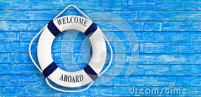 White color Life buoyancy with welcome aboard on it hanging on b Stock Photo