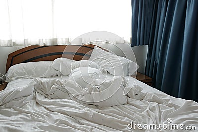 white color messy bed in early morning , messy bed after waking up Stock Photo