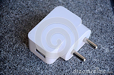 The white color mobile charger adepter on the grey background Stock Photo