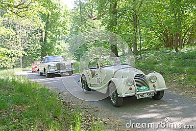 White color Morgan 4 classic car from 1958 driving on a country road Editorial Stock Photo