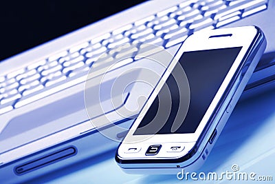 White communicator on silver laptop. Blue tint. Stock Photo