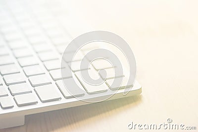 White computer keyboard on wood tabletop. Blurred abstract background for business studying freelance self-employment concept Stock Photo