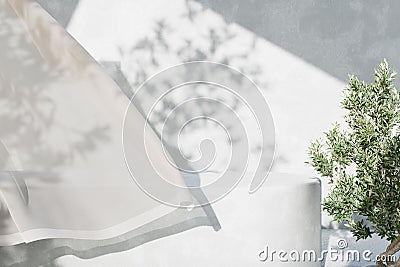 White concrete empty table, organic curtain and olive tree shadow on cement wall. Summer exterior scene for product placement Stock Photo