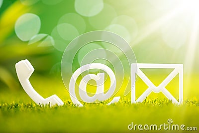 White Contact Options On Grass Stock Photo