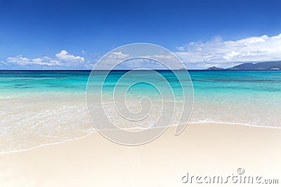 White coral beach sand and azure indian ocean. Stock Photo