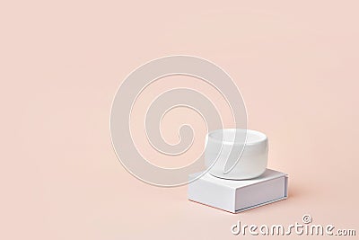 Blank white plastic container for cream, lotion, nourishing or moisturizing mask on stand. Feminine hygienic product Stock Photo