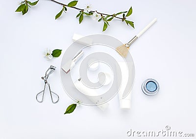 White cosmetics flat lay with flowers and leaves. Clean beauty concept Stock Photo