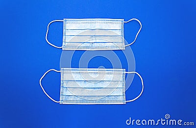 White cotton medical masks on a clasic blue background. Stock Photo