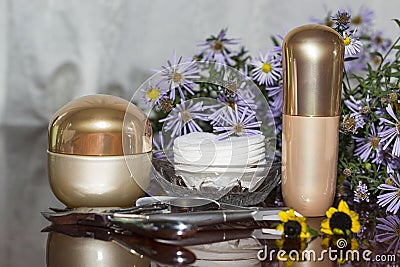 Cotton swabs, cream and nail accessories on a polished table Stock Photo