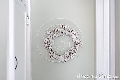 White cotton wreath on light aqua blue wall Stock Photo