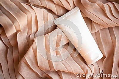 White cream tube mock-up on textile background Stock Photo