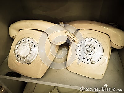 White cream Vintage Rotary desk Telephone in Aged tone photo. Stock Photo