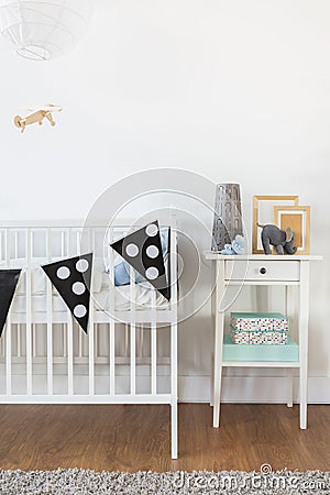 White crib and nightstand Stock Photo