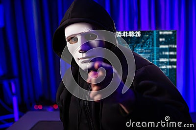 White criminal anonymous mask pointing to camera as hack programmer. Surmise. Stock Photo