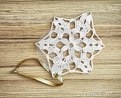 White crochet christmas decoration on the wooden texture Stock Photo