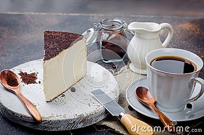 cup of black coffee with a piece of soft cheese in ground coffee Stock Photo