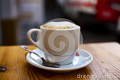 White cup with cappucino coffee with whipped hot milk Stock Photo