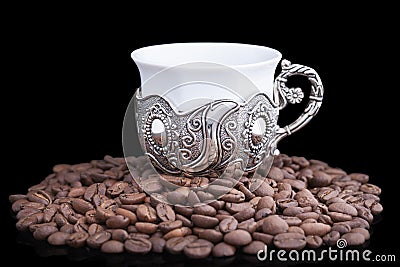 White cup with coffee beans on black background Stock Photo