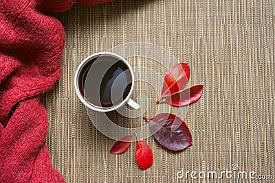 White cup of coffee on a beige background with red autumn leaves. Stock Photo