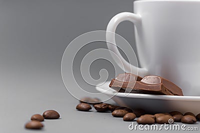 White cup of coffee with candy on a gray background Stock Photo