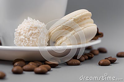 White cup of coffee with candy on a gray background Stock Photo