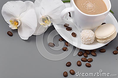 White cup of coffee with candy on a gray background Stock Photo