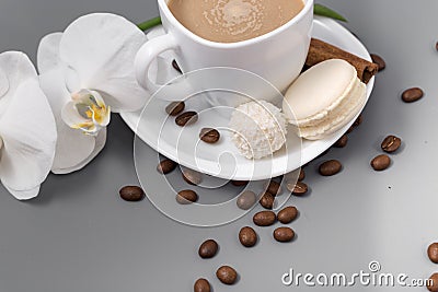 White cup of coffee with candy on a gray background Stock Photo