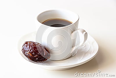 White cup of coffee and one dates white background isolated Stock Photo
