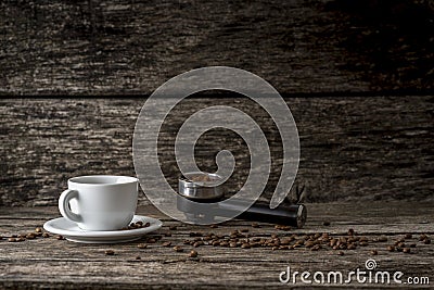 White cup of coffee, scattered coffee beans and ground coffee in Stock Photo