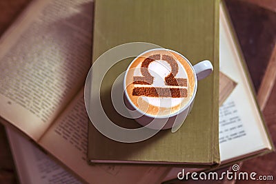 White cup of coffee with the symbol of the zodiac Libra Stock Photo
