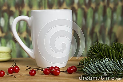 White Cup mock up with berries and pine needles on a colored background Stock Photo