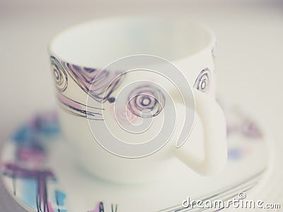 White cup and saucer on the table. Crockery for tea with a modern geometric pattern Stock Photo