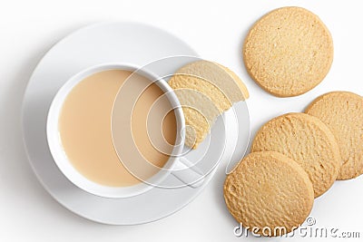 White cup of tea and saucer with shortbread biscuits from above. Stock Photo