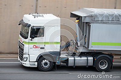 White DAF XF truck loading a white container trailer along Barcelona's Ronda Litoral Editorial Stock Photo