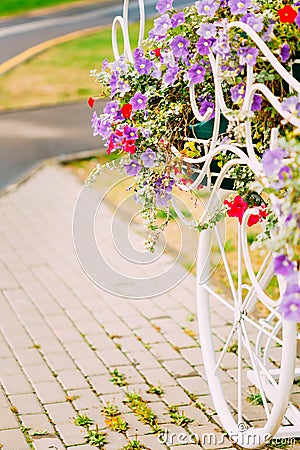 White Decorative Bicycle Parking In Garden Stock Photo