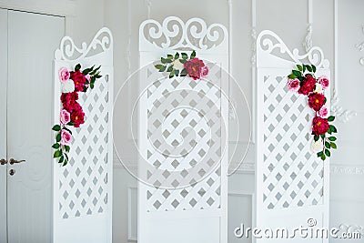 White delicate decorative wood panel in classical interior. Boudoir wedding room. Retro folding screen with flowers Stock Photo