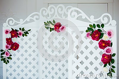 White delicate decorative wood panel in classical interior. Boudoir wedding room. Retro folding screen with flowers Stock Photo
