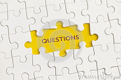 White details of puzzle with the text `Questions` on yellow background Stock Photo