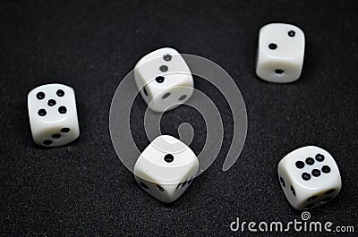 White dice,cube-shaped gaming accessories, on black background Stock Photo