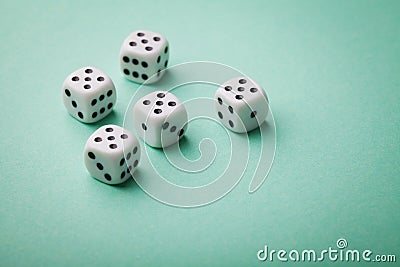 White dice on green background. Gambling devices. Copy space for text. All number five. Game of chance concept. Stock Photo