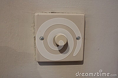 White dimmer switch white wall background Stock Photo