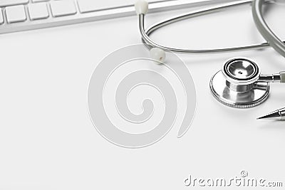 White doctor table with stethoscope and office supplies Stock Photo