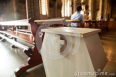 White donation box with a cross on it at a Christian church Stock Photo