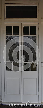 White double wooden doors with inset windows Stock Photo